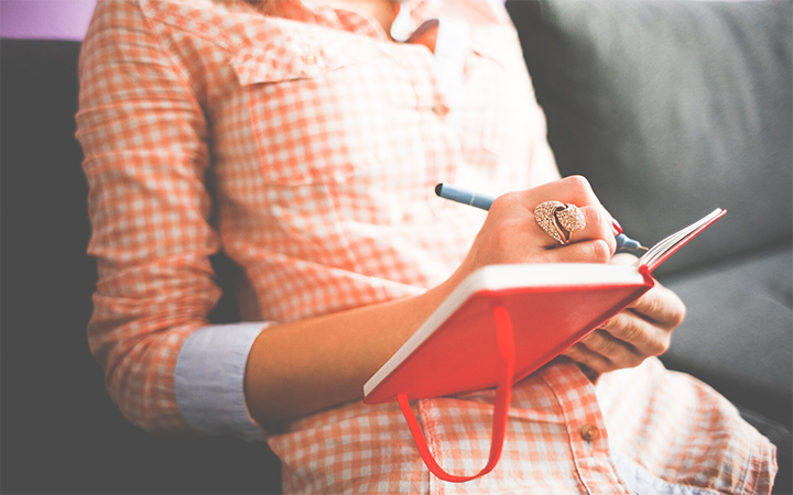 designer writing on a notebook